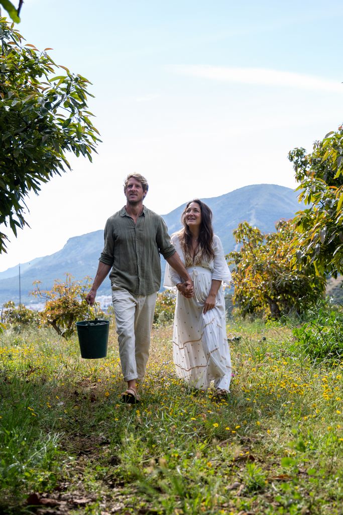 A couple walking through the orchard at Monte Valeo
