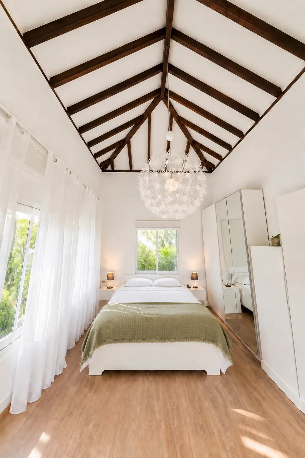 Light-filled bedroom with vaulted beamed ceiling at Villa Valeo