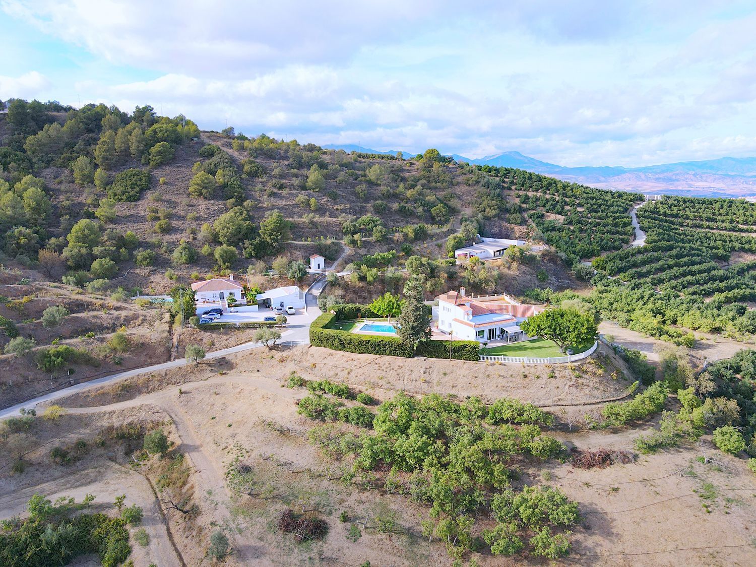 Aerial view of the Monte Valeo farm, homes and orchards in the Andalusian hills